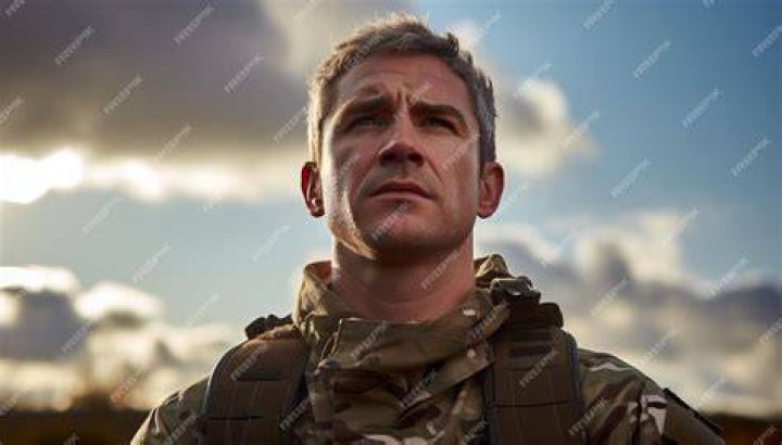 a man in uniform looking at the camera