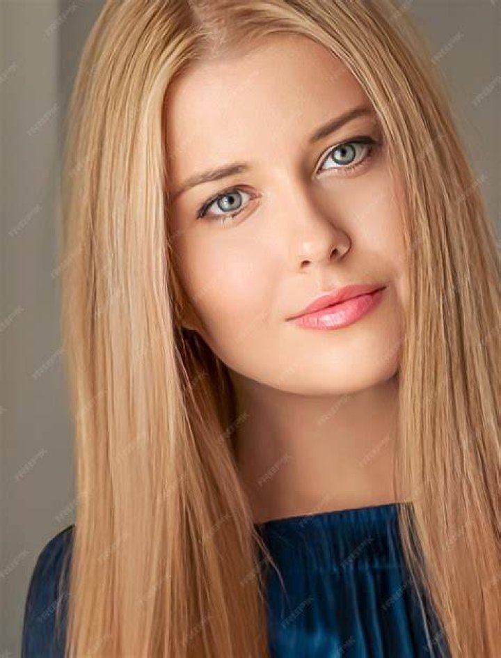 a woman with long blonde hair is laughing