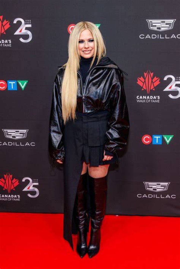 Avril Lavigne sports asymmetrical mini skirt with the tiniest new
