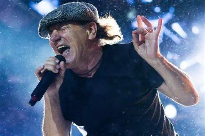 Brian Johnson lead singer of the rock group AC DC with his daughters