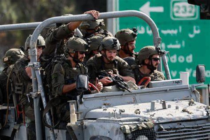 NOVEMBER 20 Palestinian gunmen ride a motorcycle as they drag the body